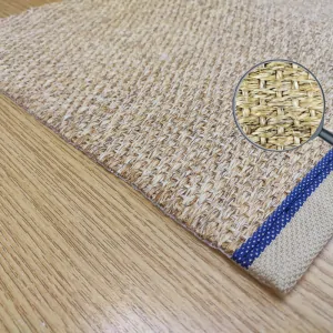 the corner of the PANAMA 111 sisal rug, with beige border, blue stitching and ecru natural mat color