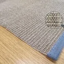 the corner of the rug Boucle 88, with a gray border, and a brownish gray mat color