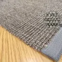 the corner of the sisal rug, with gray border and gray brown mat color