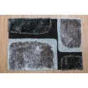 Carpet color: black background with 4 irregular squares of gray and black tufted cross-stitch