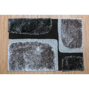 Carpet color: black background with 4 irregular squares of gray and black tufted cross-stitch