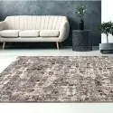 beige living room with beige-brown carpet with mosaic pattern