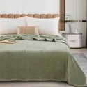 bed made with the green blanket from the company liolios home