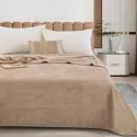 bed made with the beige sand blanket from the company liolios home