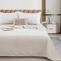 bed made with the cream ivory blanket from the company liolios home