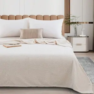 bed made with the cream ivory blanket from the company liolios home