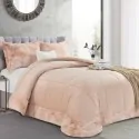 bed next to a window with the duvet, pink color and 2 matching pillows