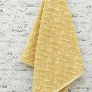 hanged dusty yellow cotton towels by Liolios Home in Leuko Korinthia