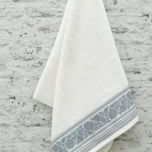 hanged white towels 100% cotton with grey pattern in a bathroom in Peloponnese
