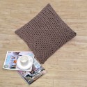 Handmade dark beige pillow as a living room decoration with knitting