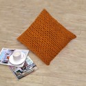 Handmade dark orange pillow as a living room decoration with knitting