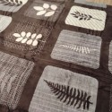 brown blanket with beige squares and leaves pattern