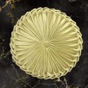 velvet gold round pillow with pleats with velvet texture, on a black background