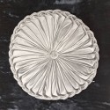 silver cream round pillow with pleats with velvet texture, on a black background