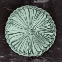 green round pillow with pleats with velvet texture, on a black background