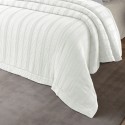 the white cotton blanket Alice on a bed in Korinthos linen store Lefko