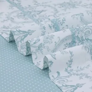 aqua floral top sheet and blue polka dot bottom sheet next to the Lefko store in Corinth