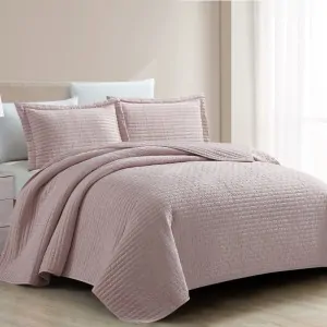 bed with dusty pink bedcover by greek liolos home in Korinthia