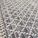 summer rug with wicker weave in gray, beige, black and with white geometric patterns such as rhombuses