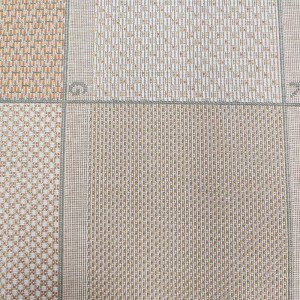 Summer synthetic rug with wicker weave in shades of beige and off-white that form squares with orange, green